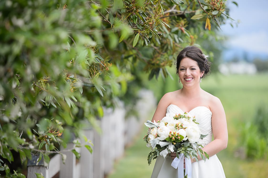 Bridal portrait while she holds flowers at Maplehurst Farms