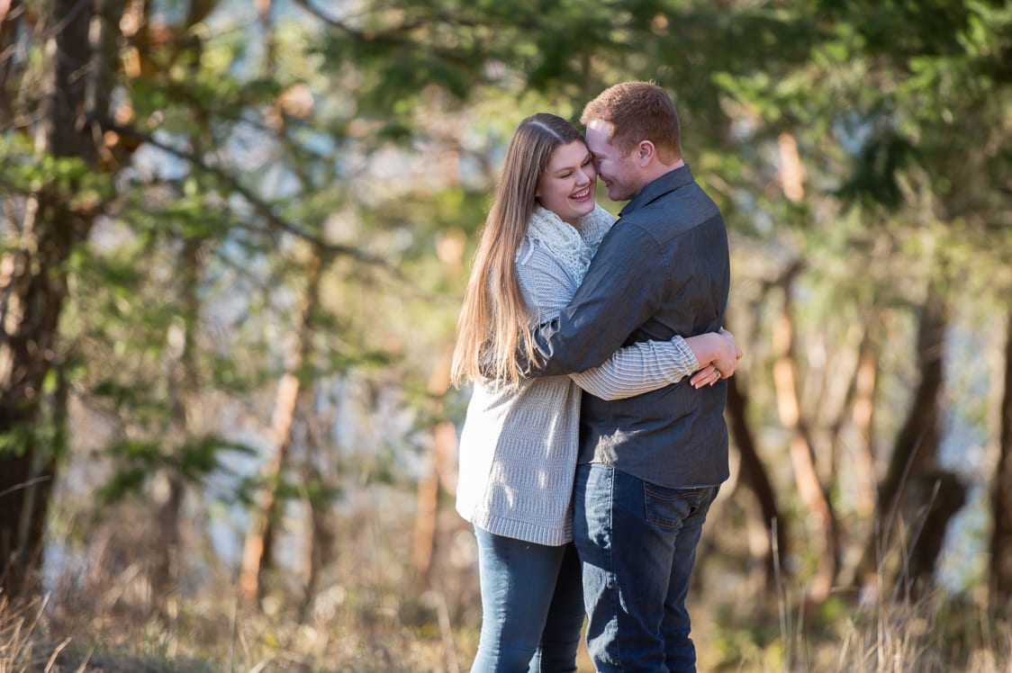 Engaged couple holding each other at Woodstock Farms