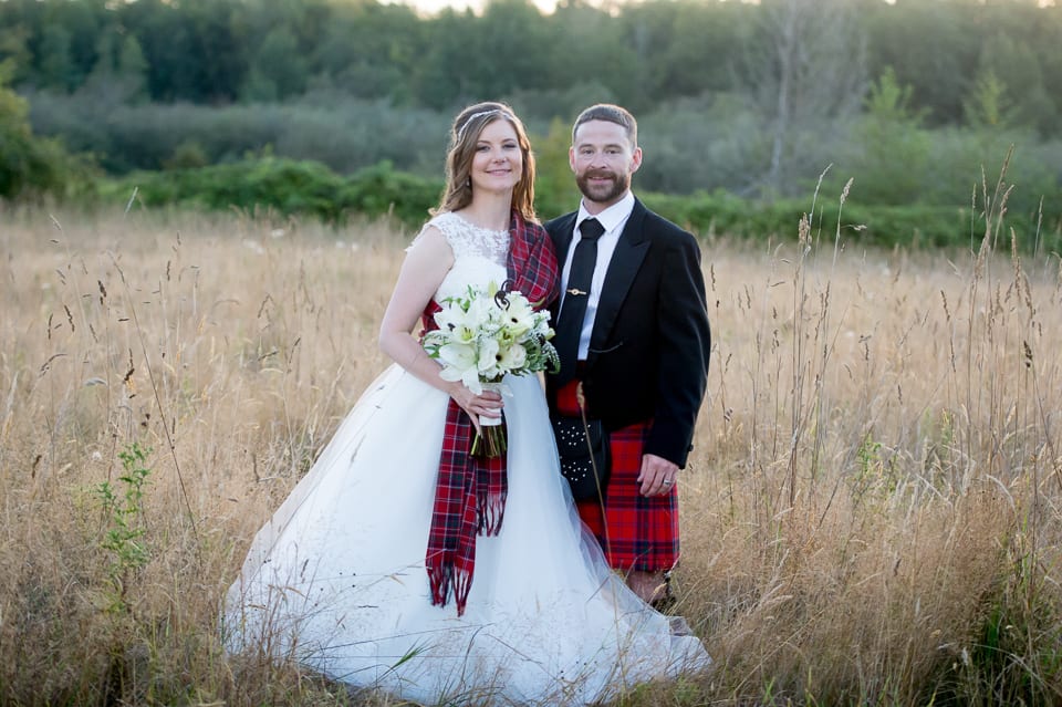 Bride and groom portraits in a field at Selene Homestead