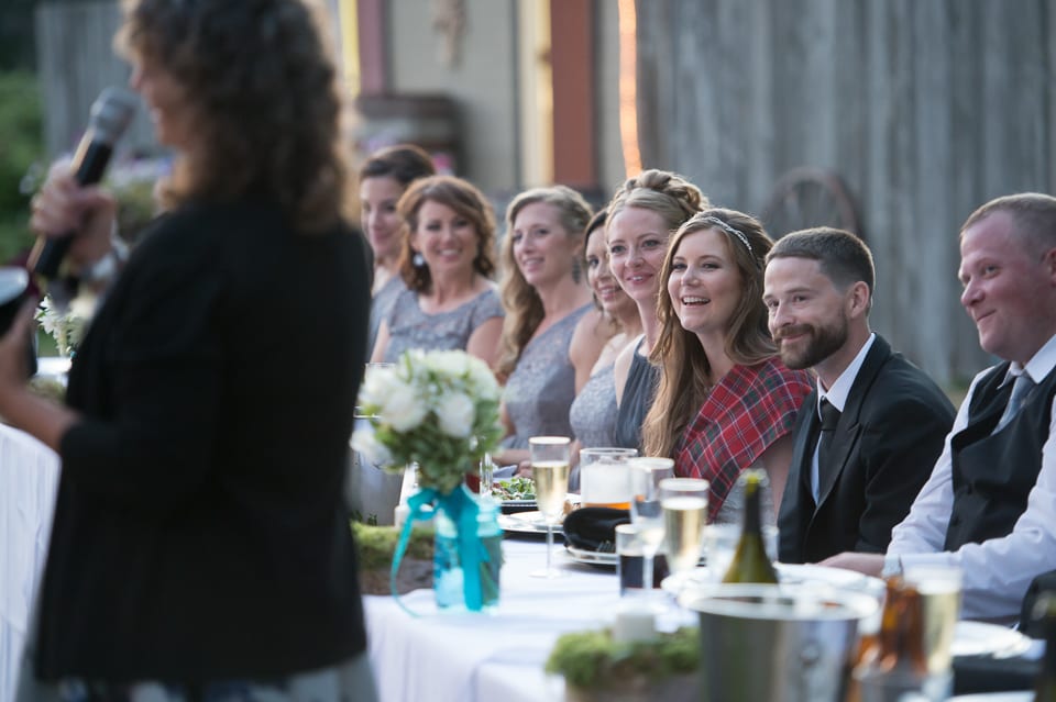 Wedding party laughing during toasts at Selene Homestead