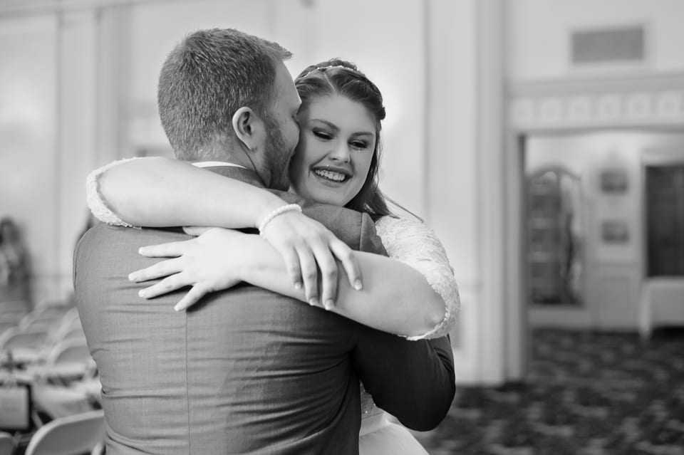 Bride and groom embrace at the Leopold Crystal Ballroom